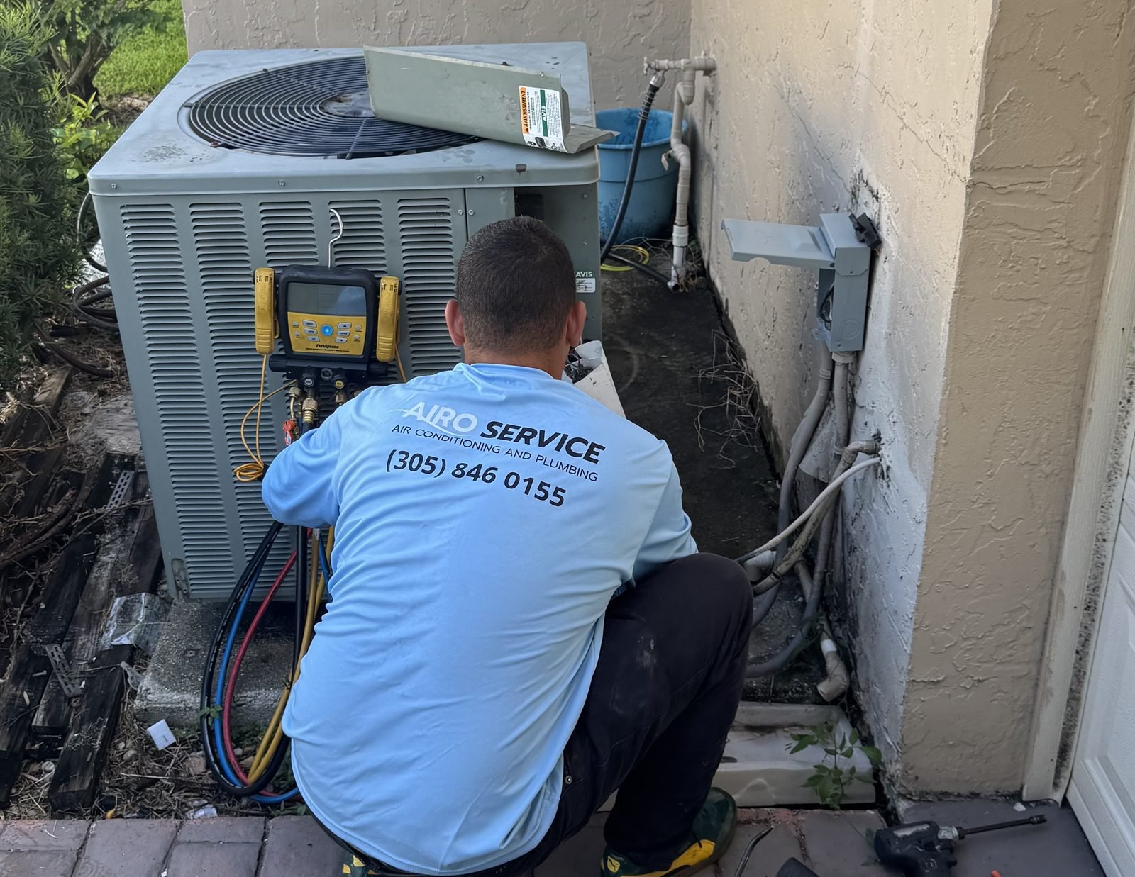Refrigerant gauges connected to a residential air conditioning system during an Airo Service diagnostic