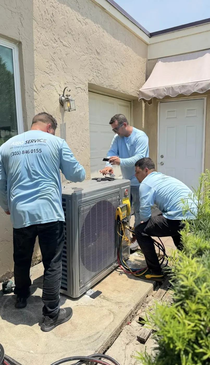 Three Airo technicians setting a new condenser
